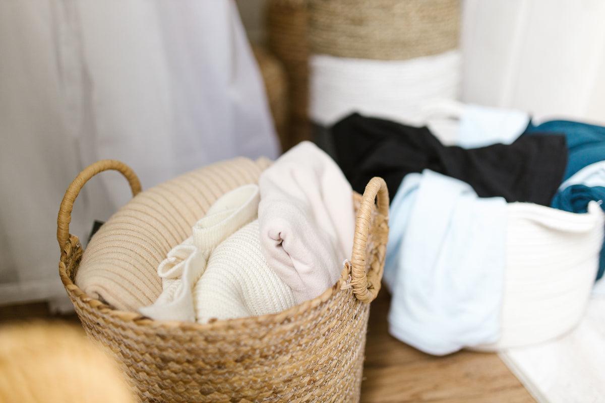 Soft clothes neatly organized in woven laundry baskets, creating a cozy and tidy indoor setting.